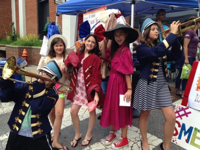 Theater kids in costume at the festival booth