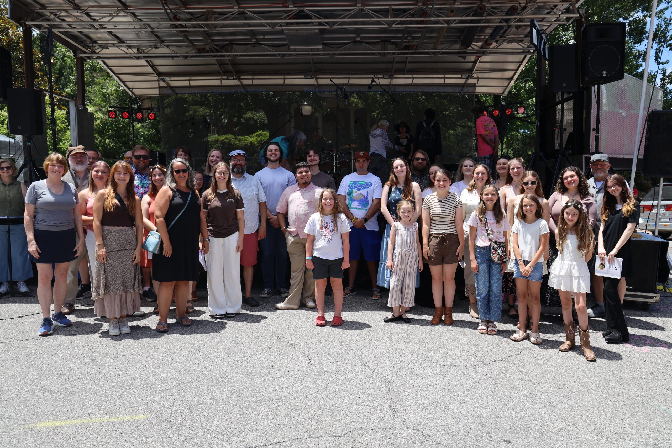 A group of people standing outside and smiling.